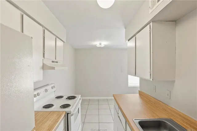 a room with window and cabinets