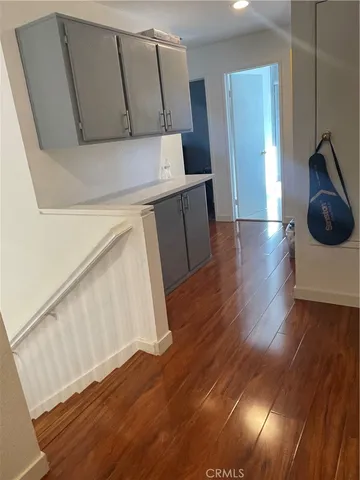 a kitchen with cabinets and wooden floor