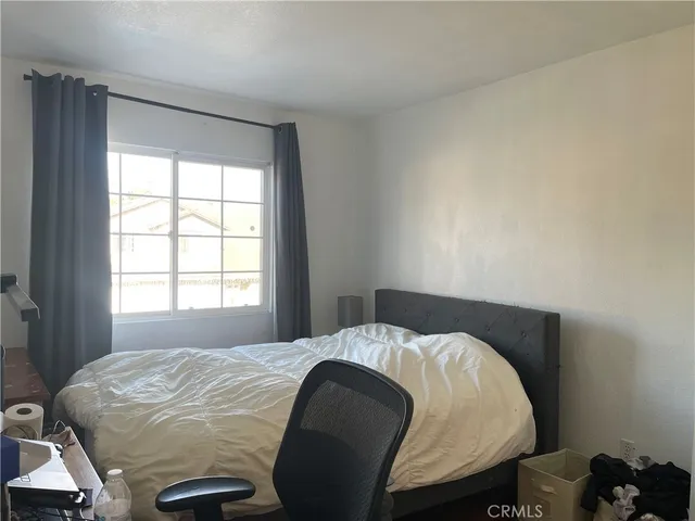 a bedroom with a bed and window