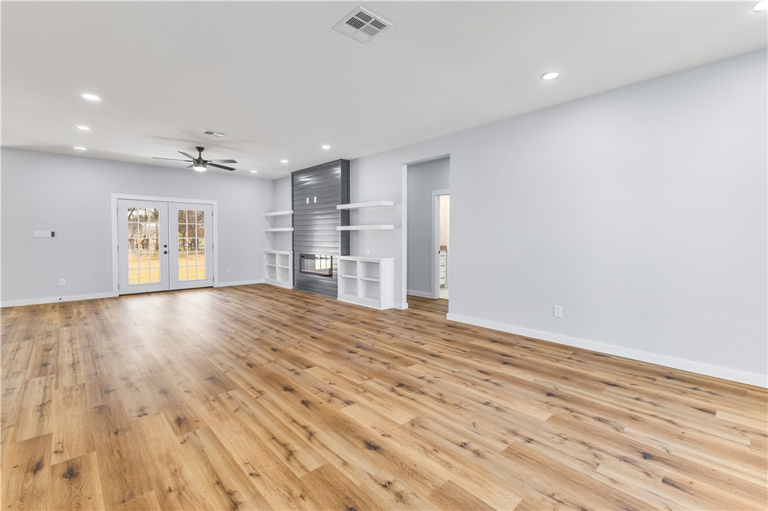 308 Crye Circle Winters, TX 79567 - Photo 16 of 44 an empty room with wooden floor cabinet and windows