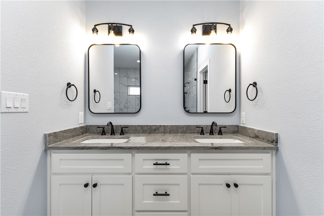 308 Crye Circle Winters, TX 79567 - Photo 33 of 44 a bathroom with double vanity sinks and a mirror