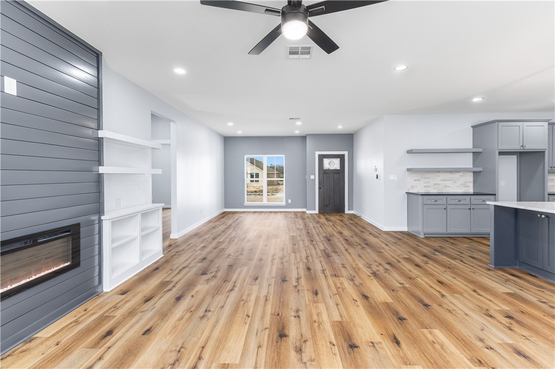 308 Crye Circle Winters, TX 79567 - Photo 6 of 44 a view of empty room with wooden floor and fireplace