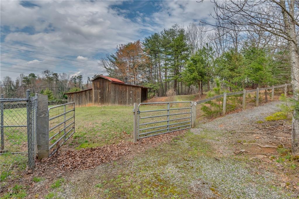 83 Luther Durham Road Tryon, NC 28782 - Photo 19 of 43 a backyard of a house with lots of green space