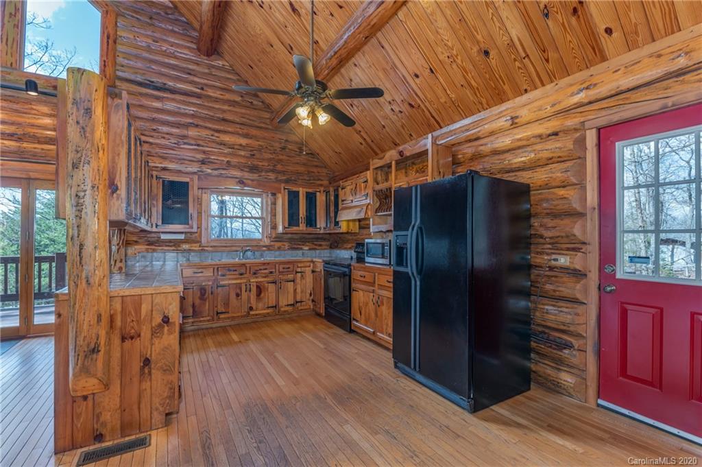 83 Luther Durham Road Tryon, NC 28782 - Photo 25 of 43 a kitchen with stainless steel appliances granite countertop a refrigerator a stove and wooden floors