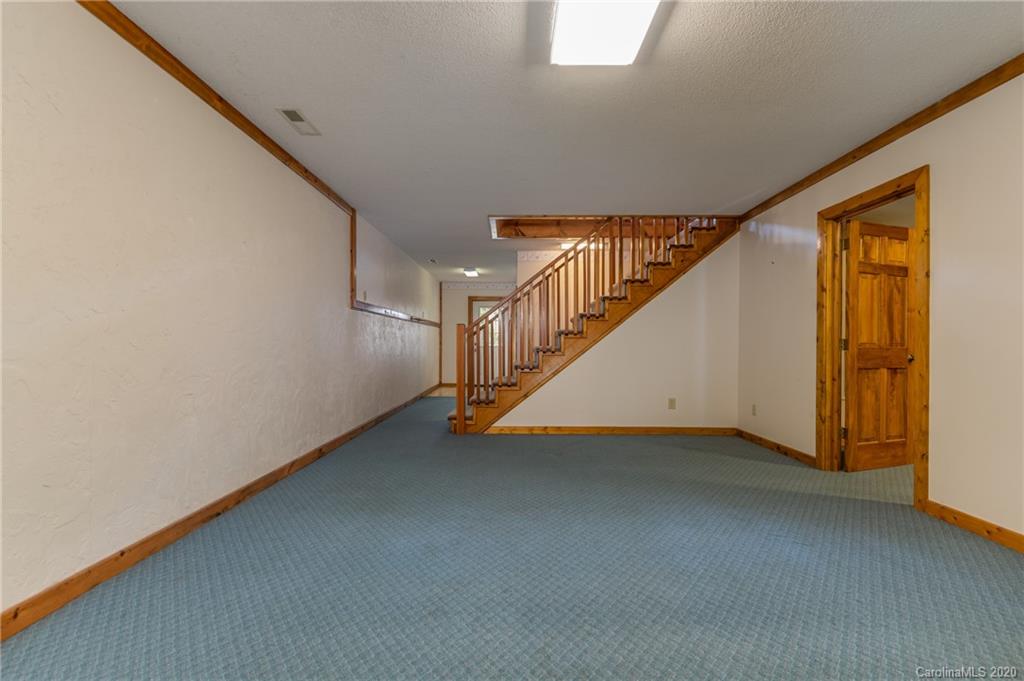 83 Luther Durham Road Tryon, NC 28782 - Photo 38 of 43 a view of an empty room with stairs