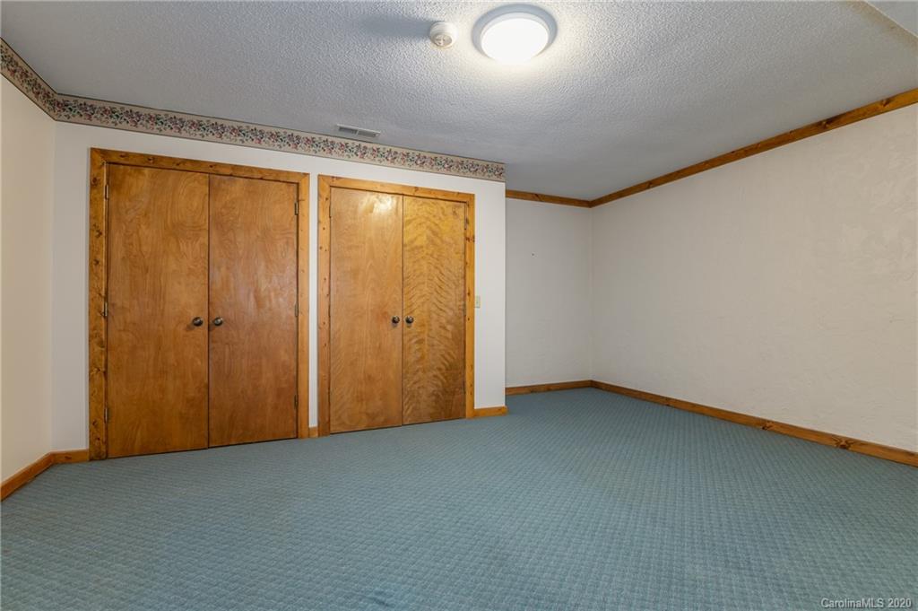 83 Luther Durham Road Tryon, NC 28782 - Photo 39 of 43 an empty room with a empty space and a window