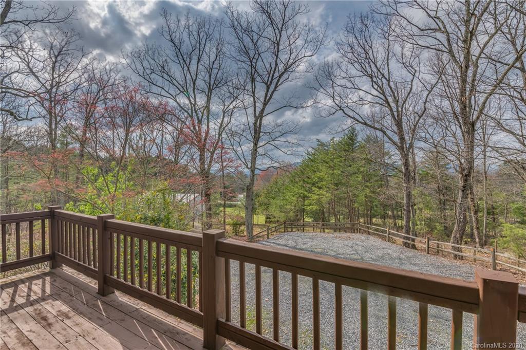 83 Luther Durham Road Tryon, NC 28782 - Photo 40 of 43 a view of a wooden deck and trees with wooden fence