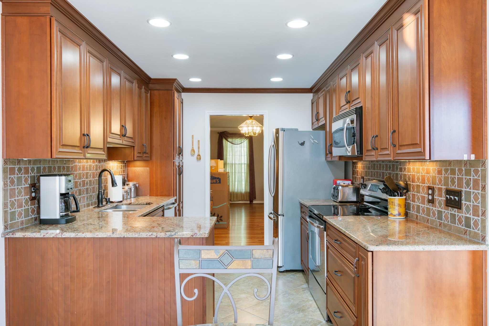 1359 General George Patton Road Nashville, TN 37221 - Photo 16 of 41 a kitchen with stainless steel appliances granite countertop a sink a stove and a refrigerator