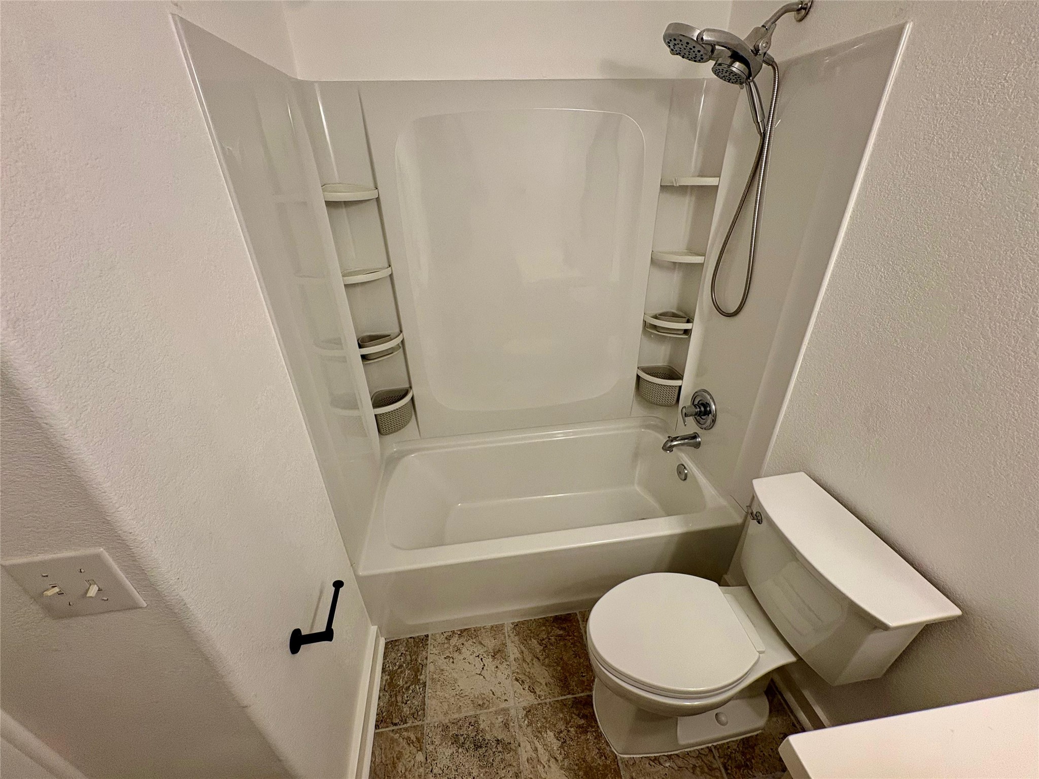 8003 Bannock Lane Austin, TX 78747 - Photo 34 of 40 Bathroom featuring a textured wall and shower combination