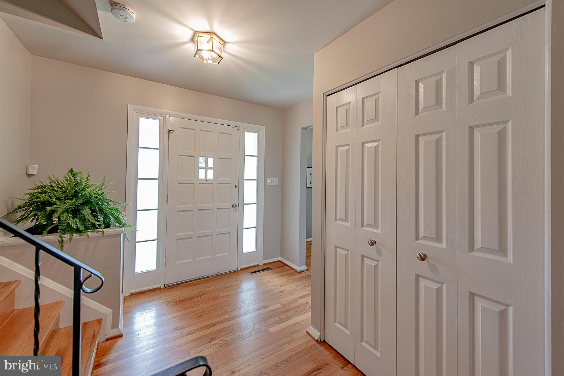 Freshly Painted Foyer with Gleaming Hardwoods