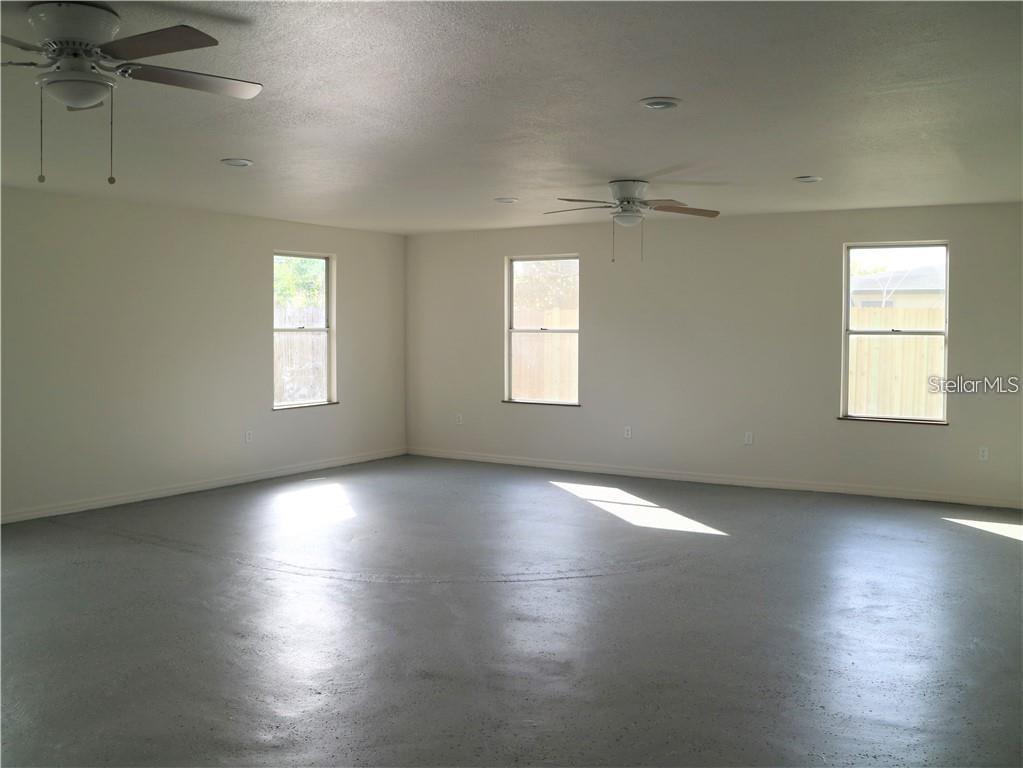 4102 Darlington Road Holiday, FL 34691 - Photo 5 of 9 an empty room with wooden floor and windows