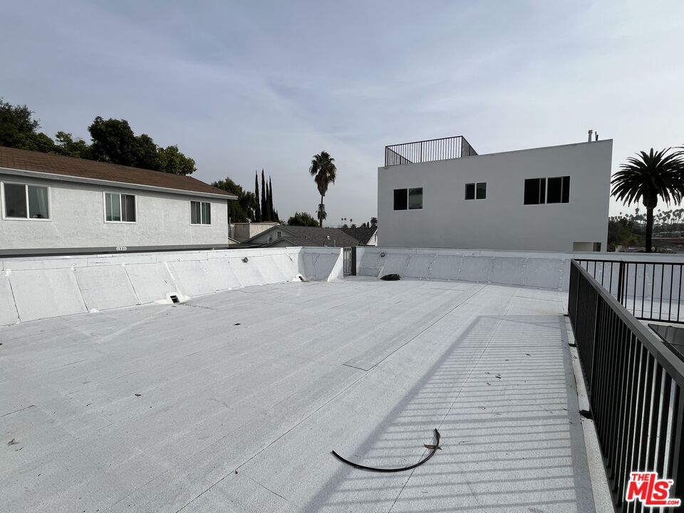 1339 South Hudson Avenue Los Angeles, CA 90019 - Photo 3 of 17 a view of a house with a backyard