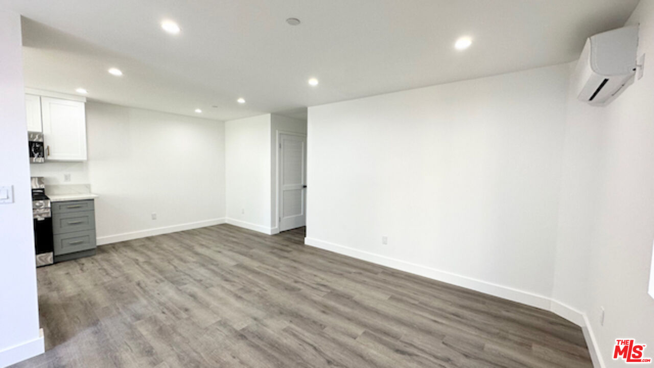 1339 South Hudson Avenue Los Angeles, CA 90019 - Photo 5 of 17 a view of empty room with wooden floor