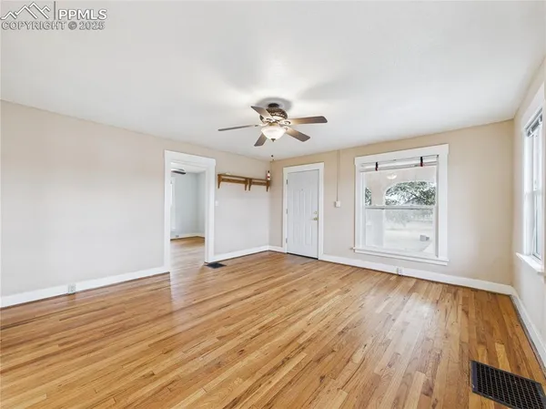 wooden floor in an empty room with a window