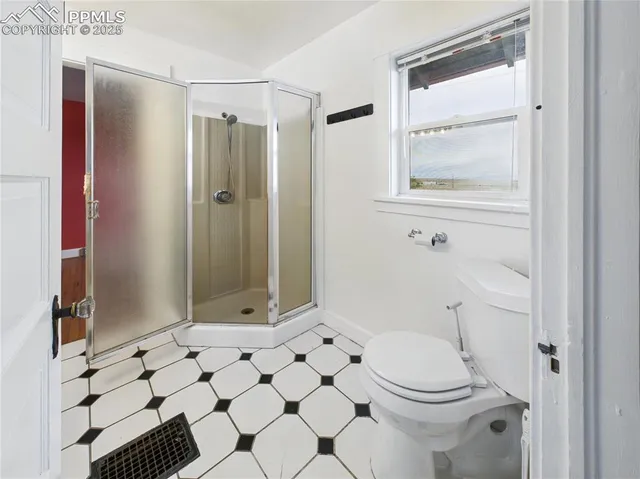 a bathroom with a toilet a sink and a shower