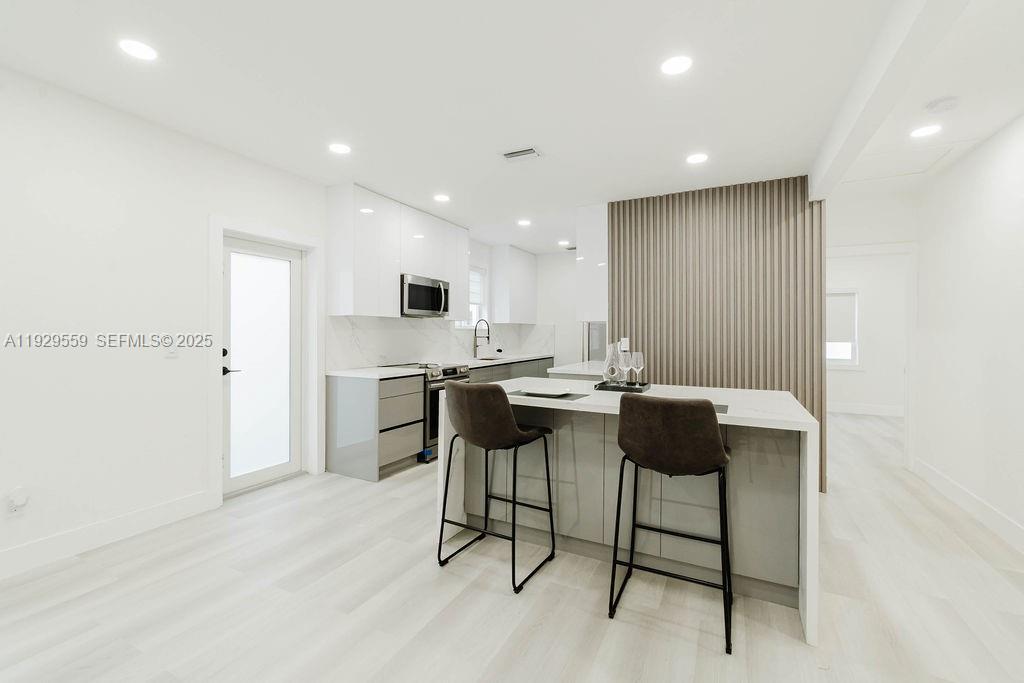 2101 Southwest 16th Terrace Miami, FL 33145 - Photo 6 of 55 a kitchen with a table and chairs in it