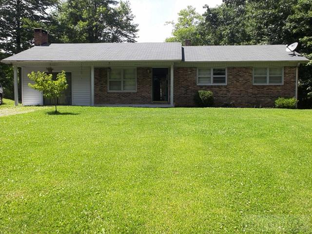 2841 Glade Valley Road Sparta, NC 28675 - Photo 1 of 15 a front view of a house with a garden