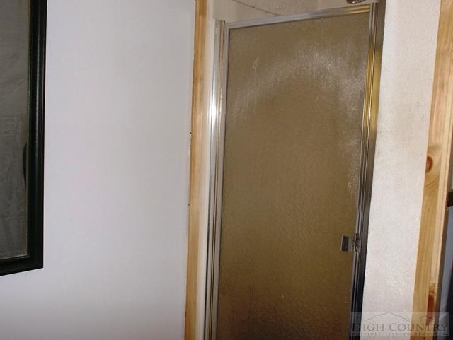 2841 Glade Valley Road Sparta, NC 28675 - Photo 12 of 15 a bathroom with a glass shower door
