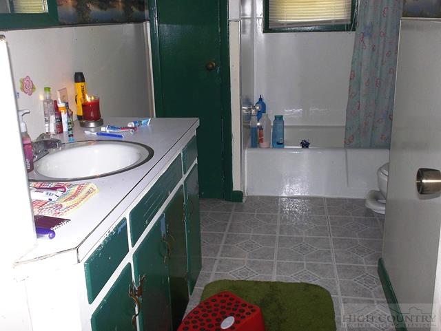 2841 Glade Valley Road Sparta, NC 28675 - Photo 14 of 15 a bathroom with a sink a bathtub and a mirror