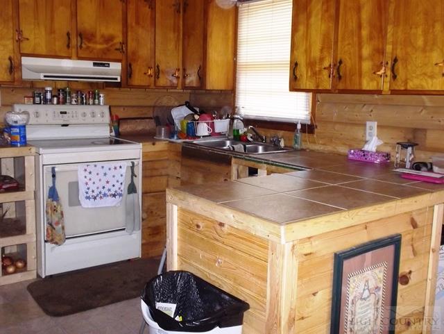 2841 Glade Valley Road Sparta, NC 28675 - Photo 9 of 15 a kitchen with a stove and cabinets