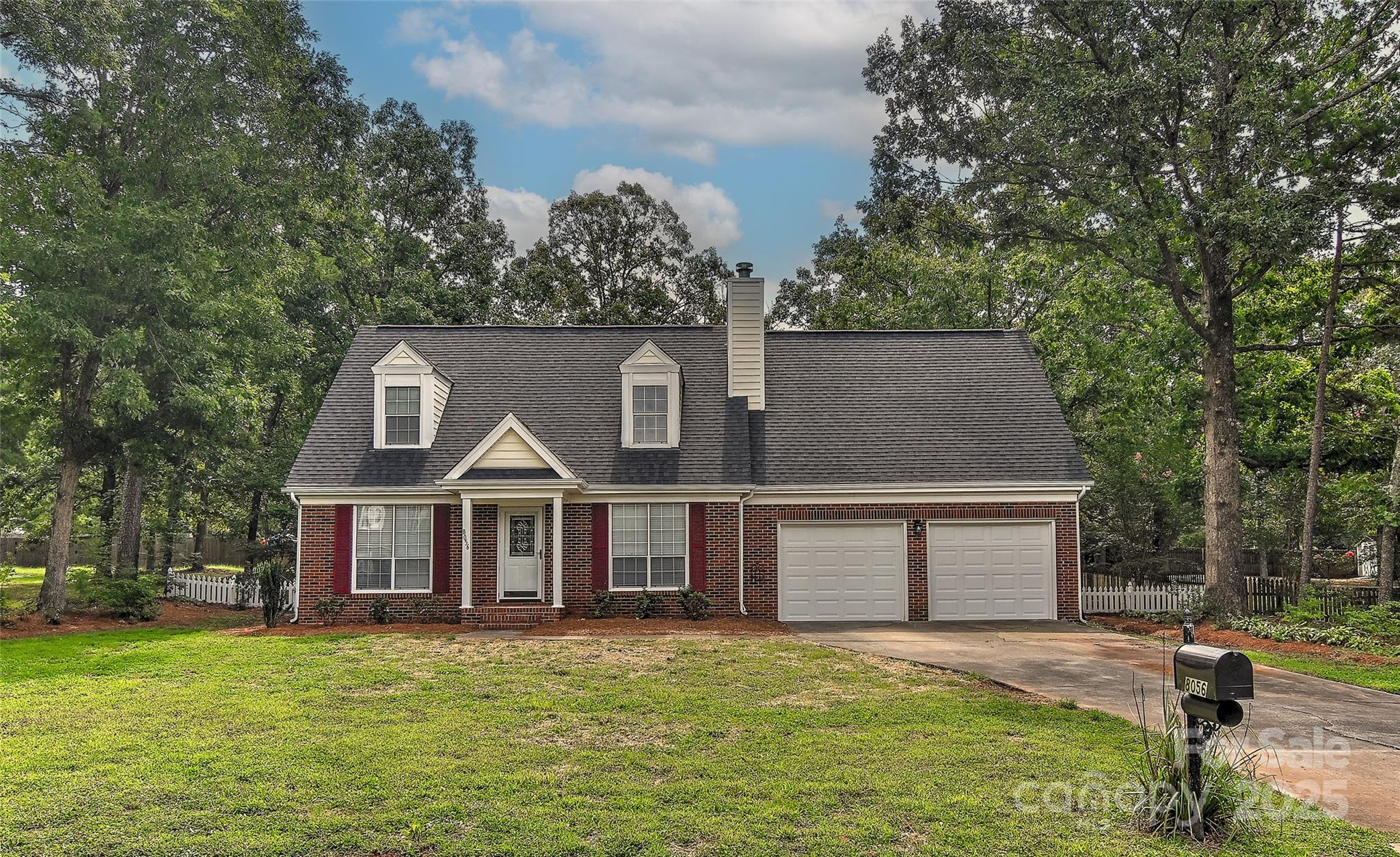 8056 Hunley Ridge Road Matthews, NC 28104 - Photo 1 of 37 a view of a big house with a big yard and large trees