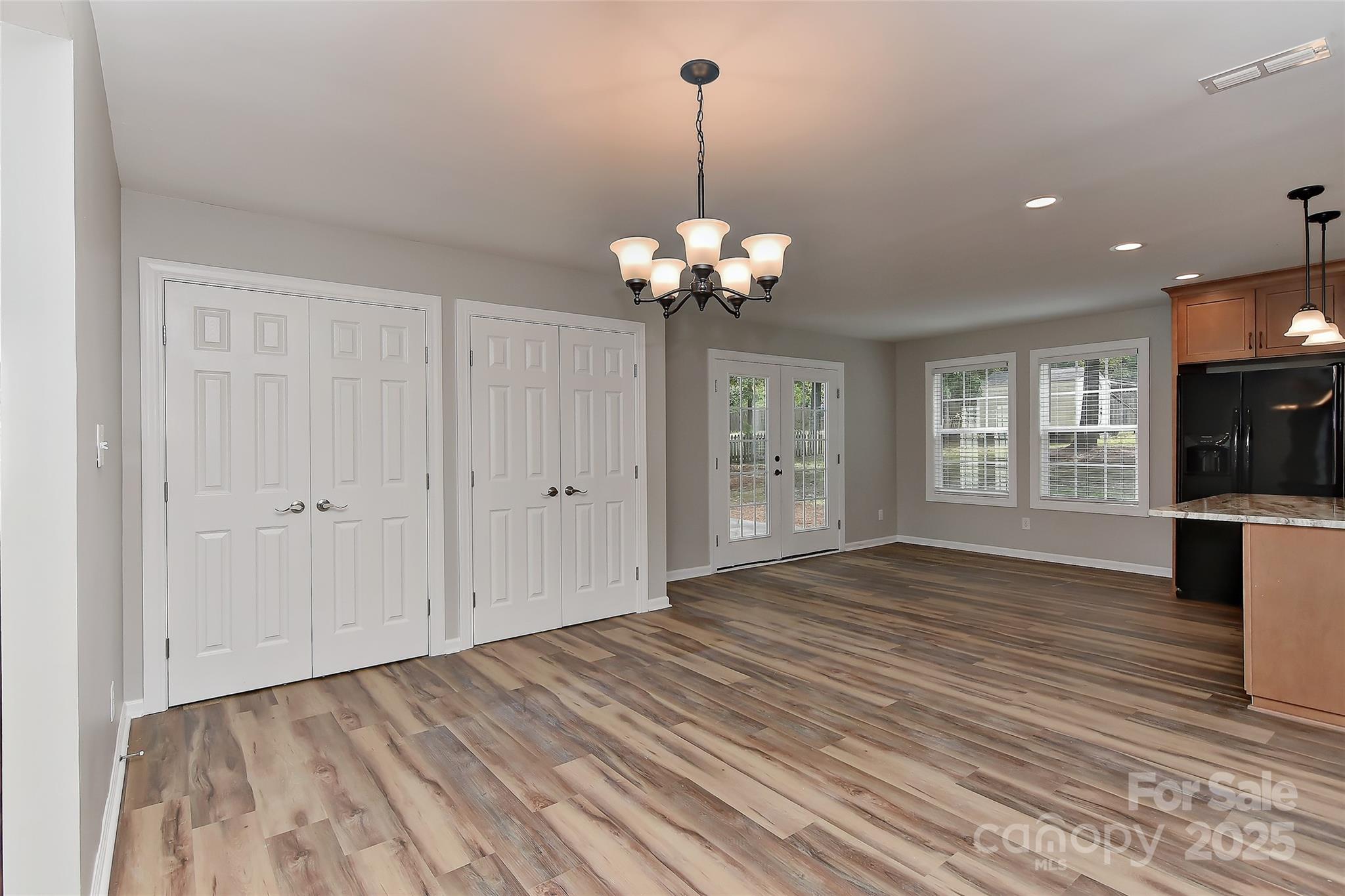 8056 Hunley Ridge Road Matthews, NC 28104 - Photo 11 of 37 a view of a livingroom with a chandelier fan and wooden floor