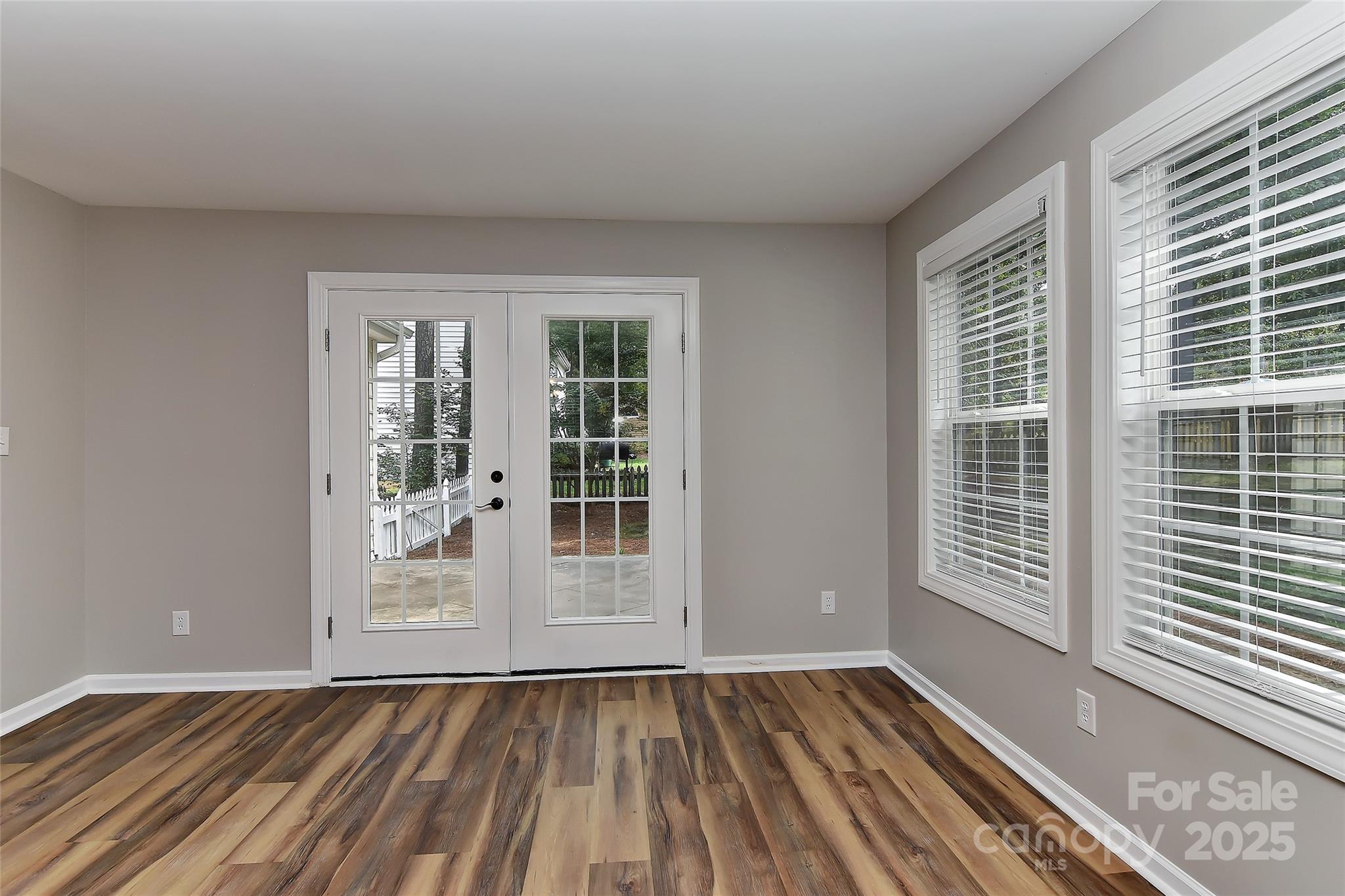 8056 Hunley Ridge Road Matthews, NC 28104 - Photo 12 of 37 a view of an empty room with wooden floor and a window