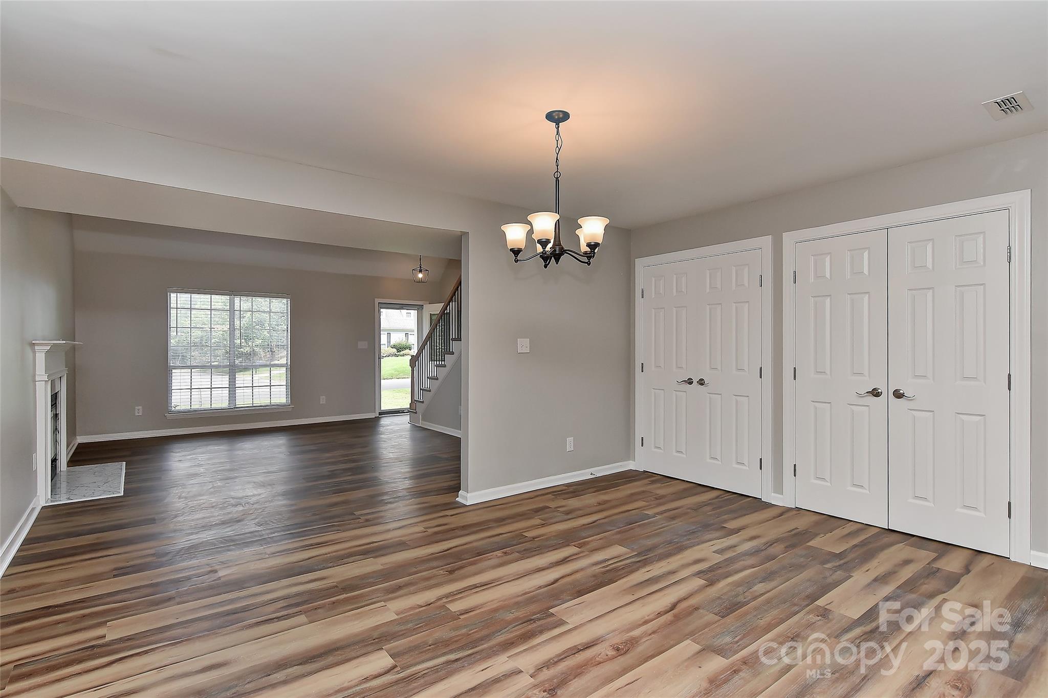 8056 Hunley Ridge Road Matthews, NC 28104 - Photo 13 of 37 a view of an empty room with window and wooden floor