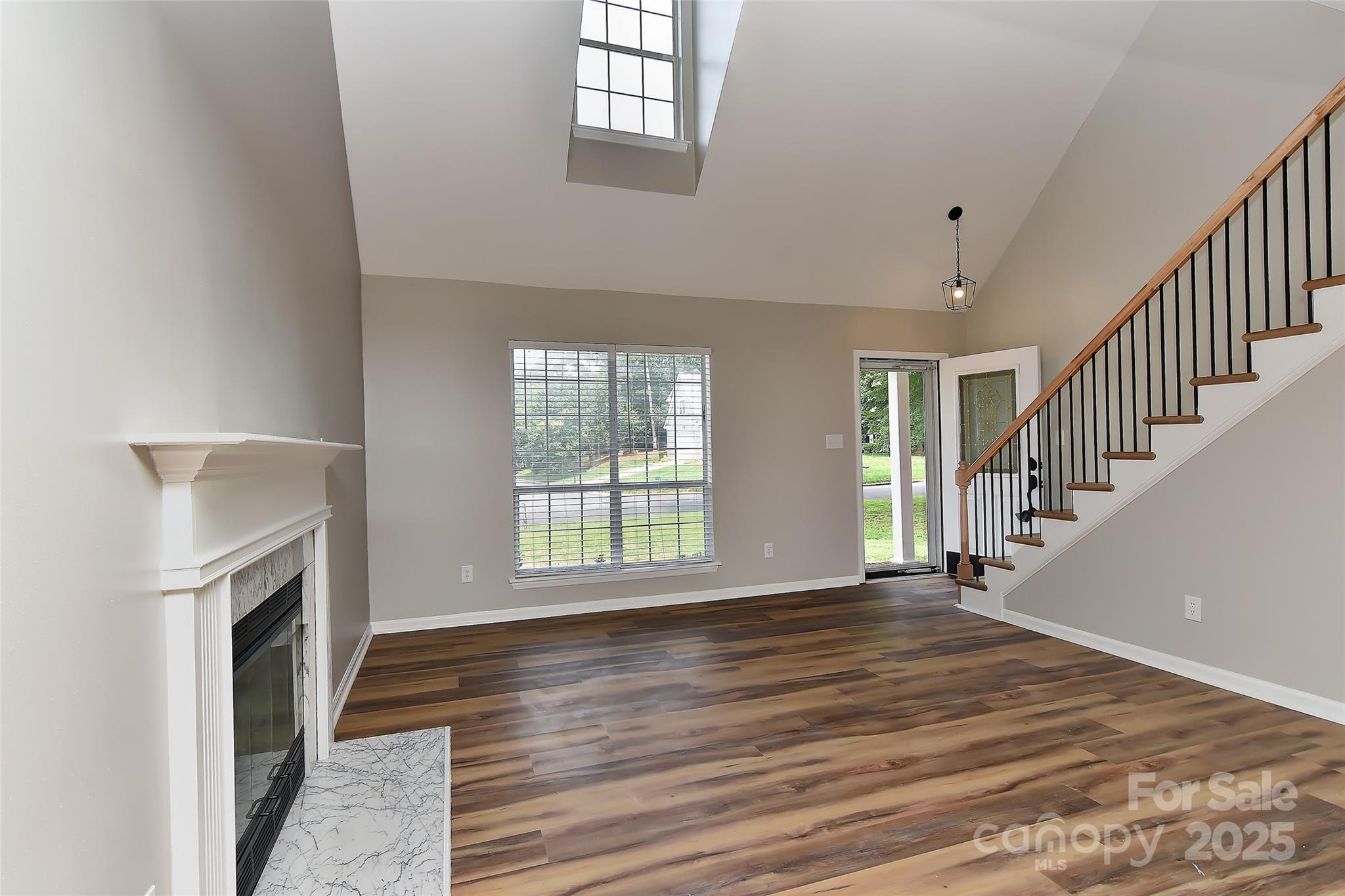 8056 Hunley Ridge Road Matthews, NC 28104 - Photo 15 of 37 a view of an empty room with wooden floor and a window