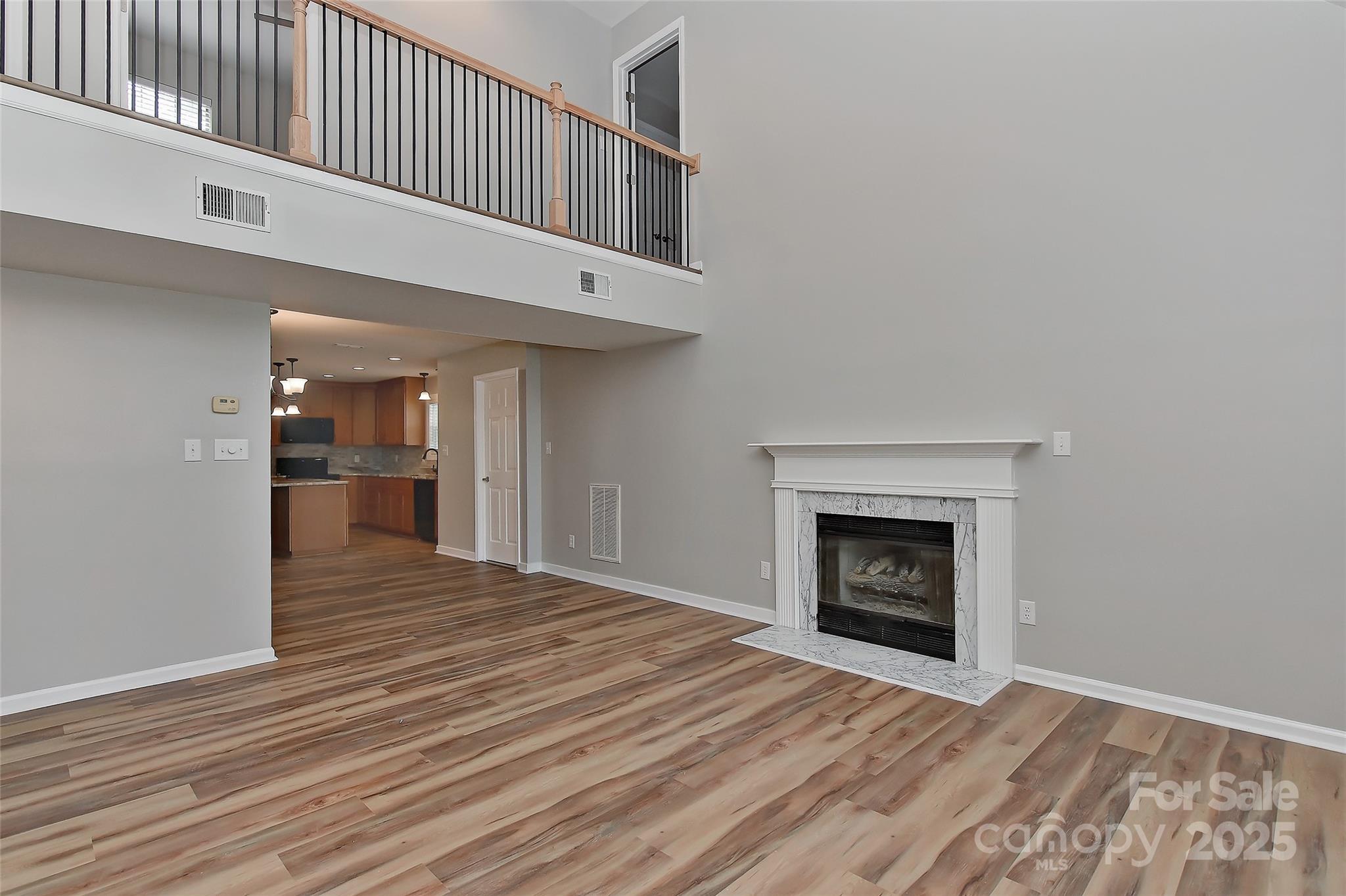 8056 Hunley Ridge Road Matthews, NC 28104 - Photo 16 of 37 a view of an empty room with wooden floor fireplace and a window