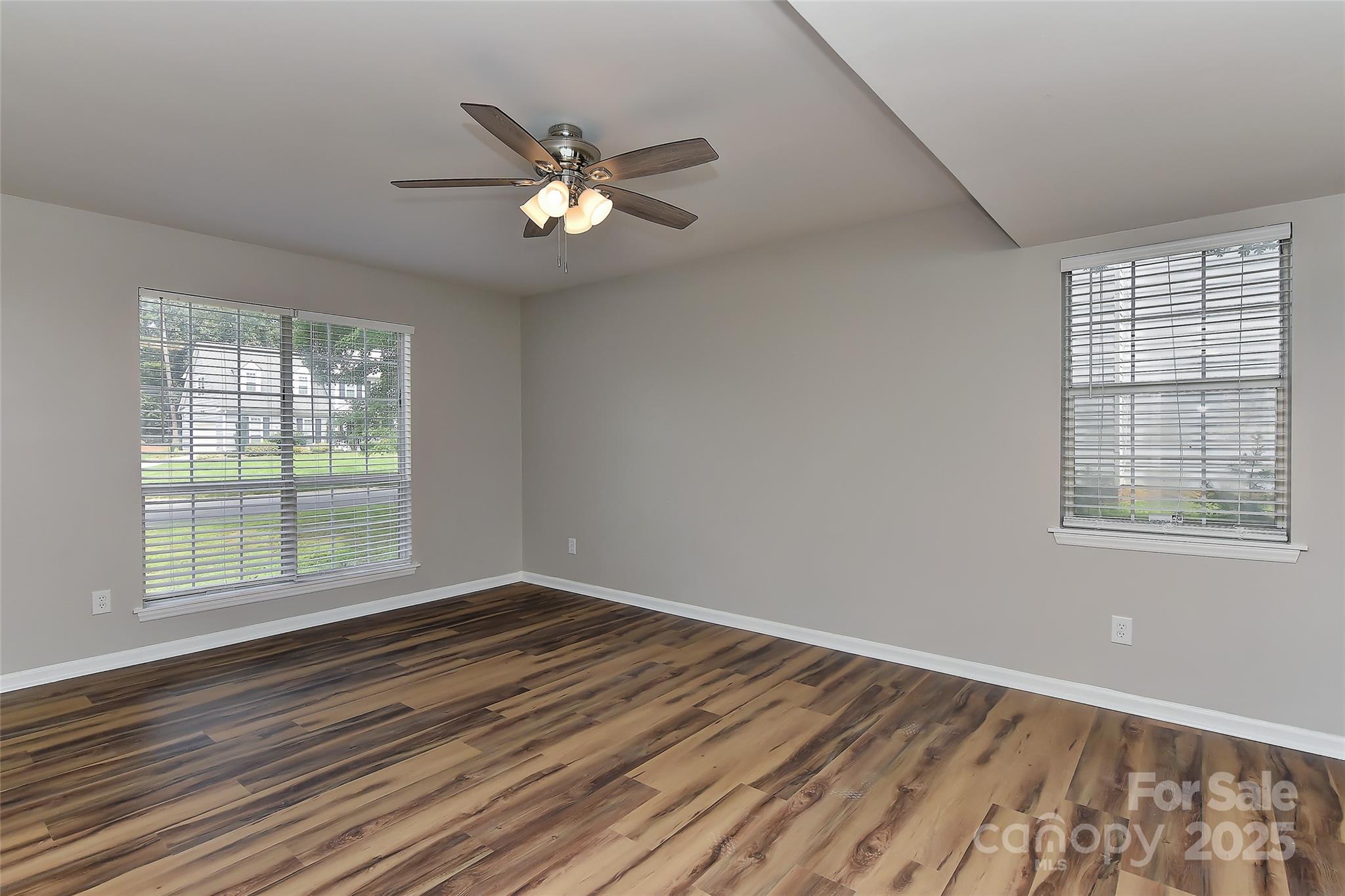 8056 Hunley Ridge Road Matthews, NC 28104 - Photo 20 of 37 a view of an empty room with wooden floor and a window