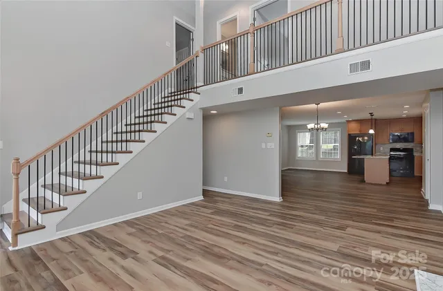 a view of a kitchen with granite countertop stainless steel appliances and wooden floor