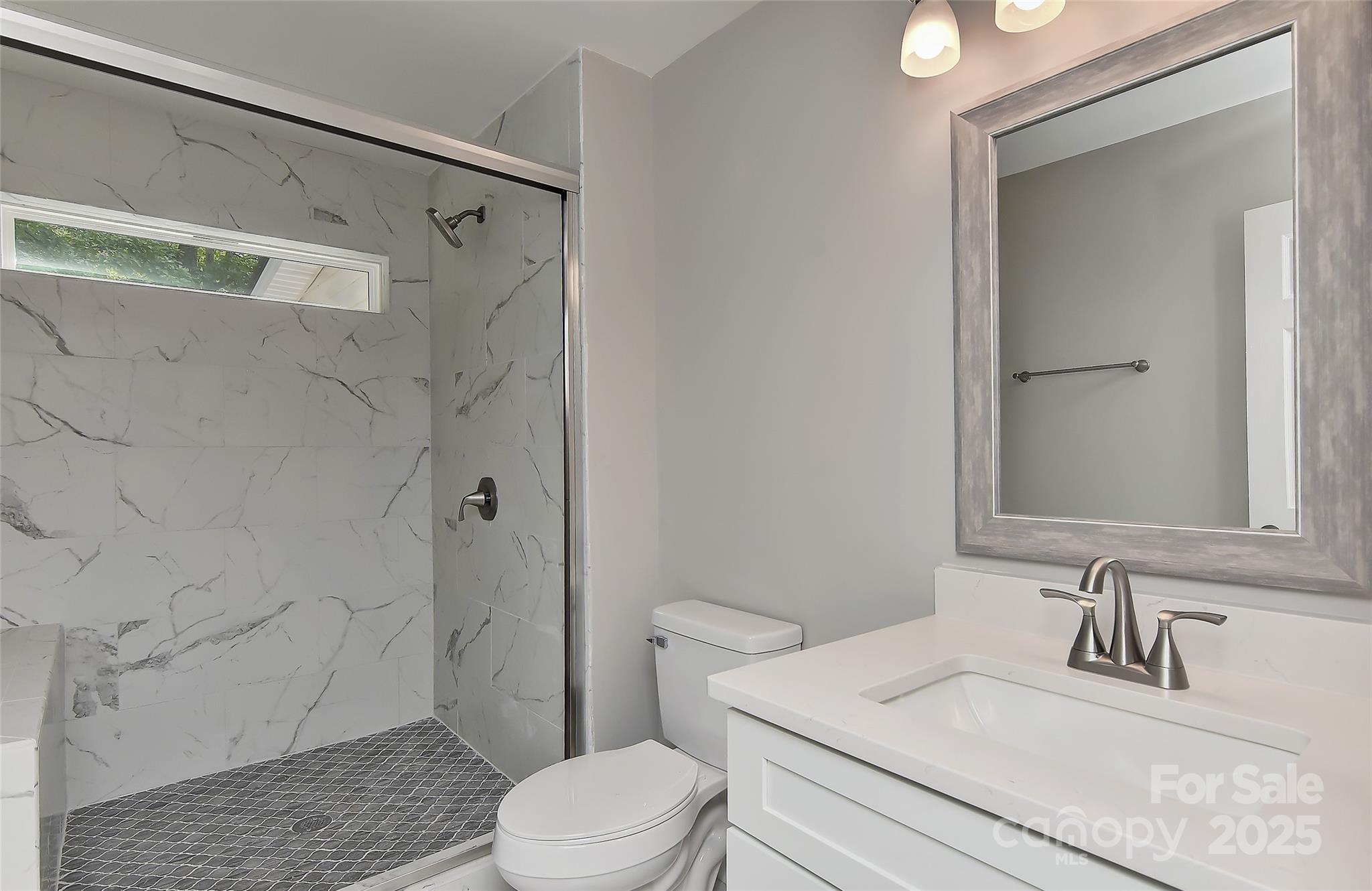 8056 Hunley Ridge Road Matthews, NC 28104 - Photo 22 of 37 a bathroom with a sink a toilet and shower