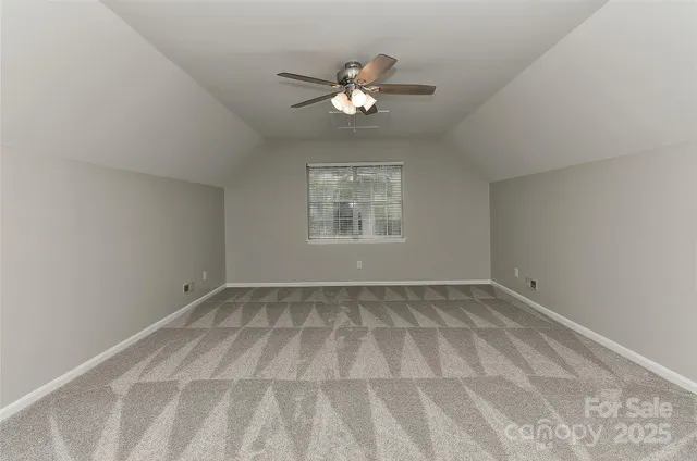 a view of a livingroom with a ceiling fan and window