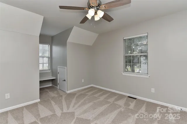 a view of a hallway to a chandelier