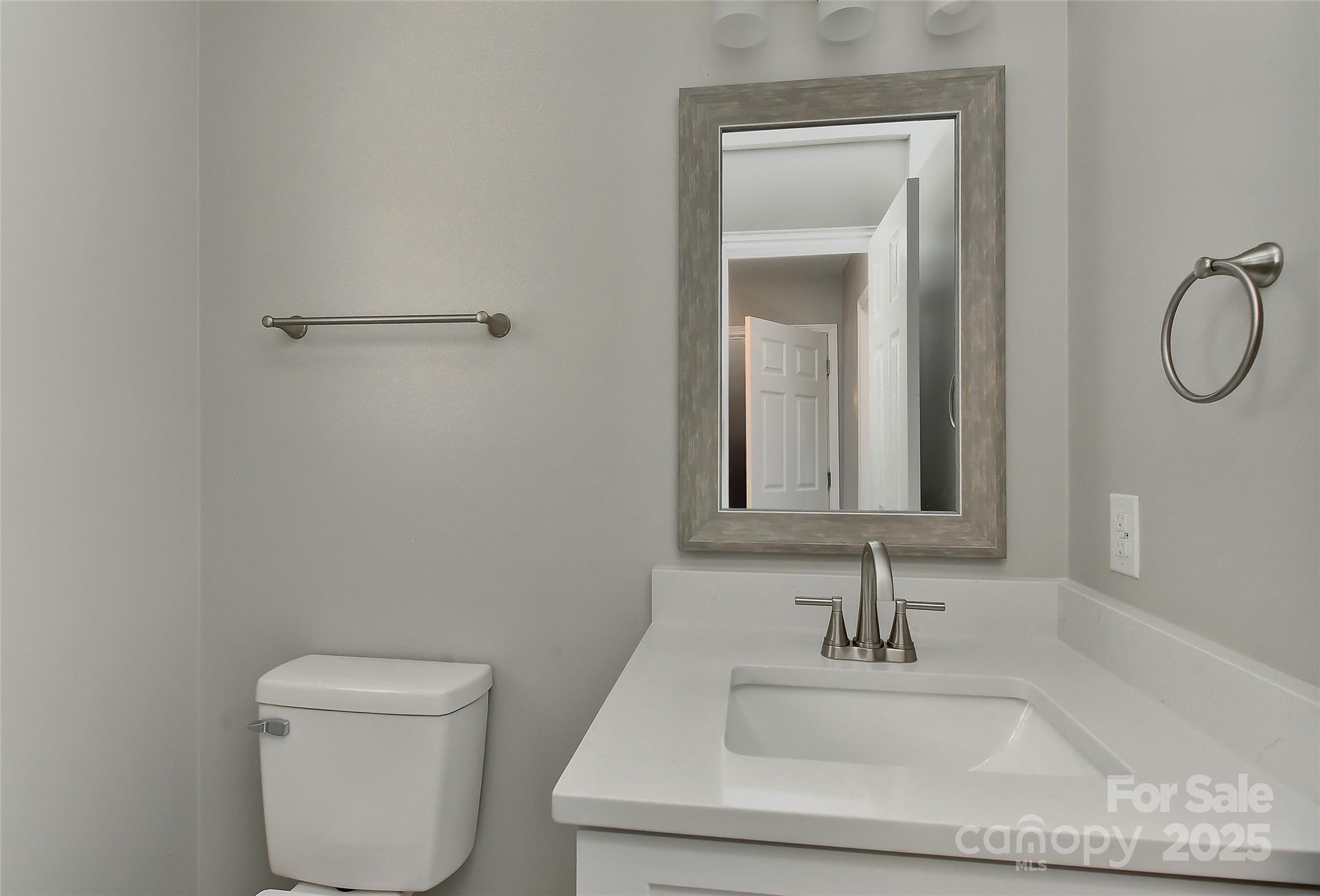 8056 Hunley Ridge Road Matthews, NC 28104 - Photo 32 of 37 a bathroom with a sink a toilet and a mirror