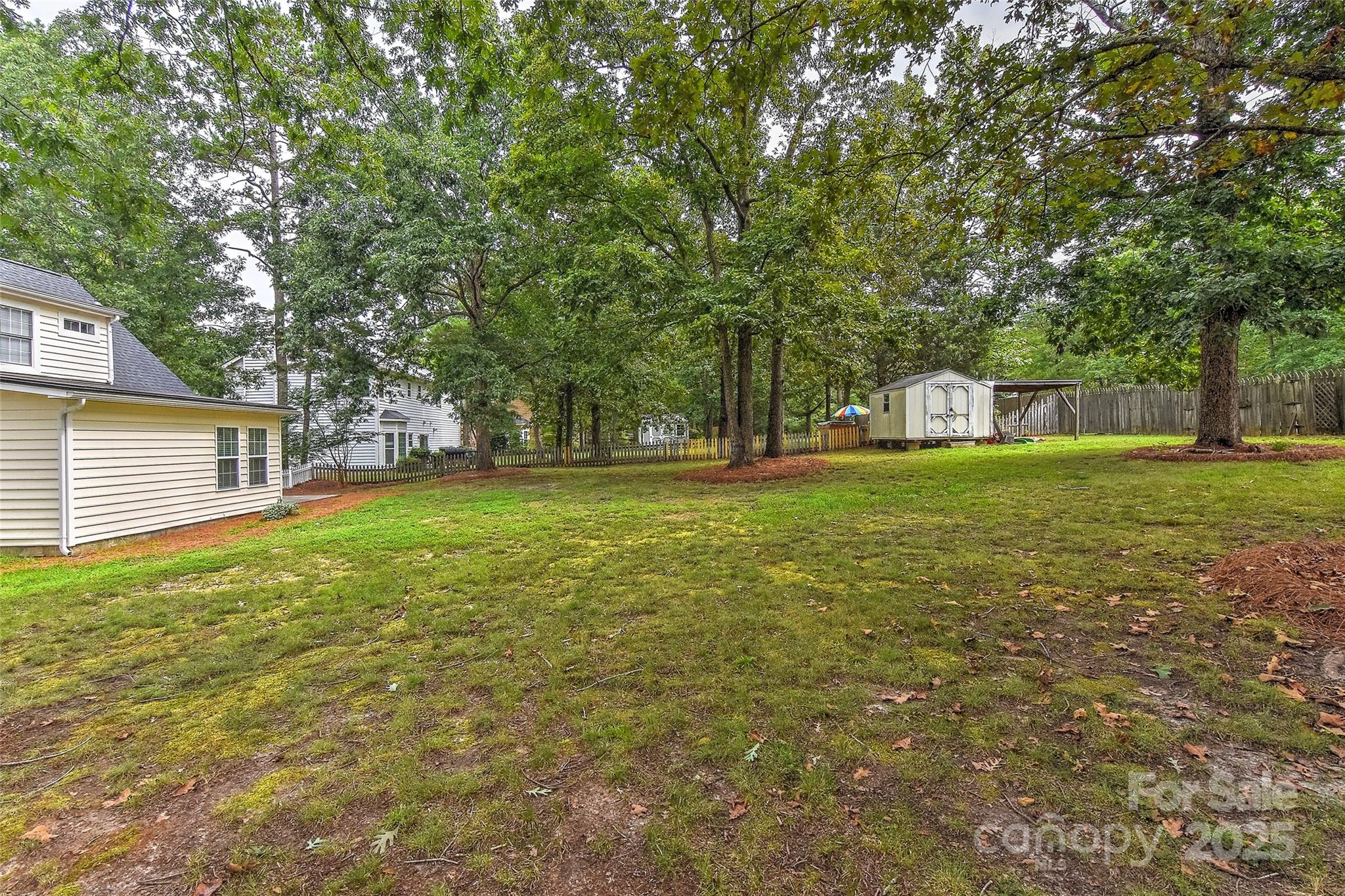 8056 Hunley Ridge Road Matthews, NC 28104 - Photo 36 of 37 a view of a tree in front of a house with a big yard