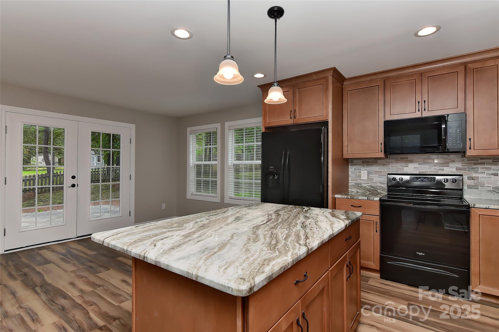 8056 Hunley Ridge Road Matthews, NC 28104 - Photo 6 of 37 a kitchen with kitchen island a sink stainless steel appliances and cabinets