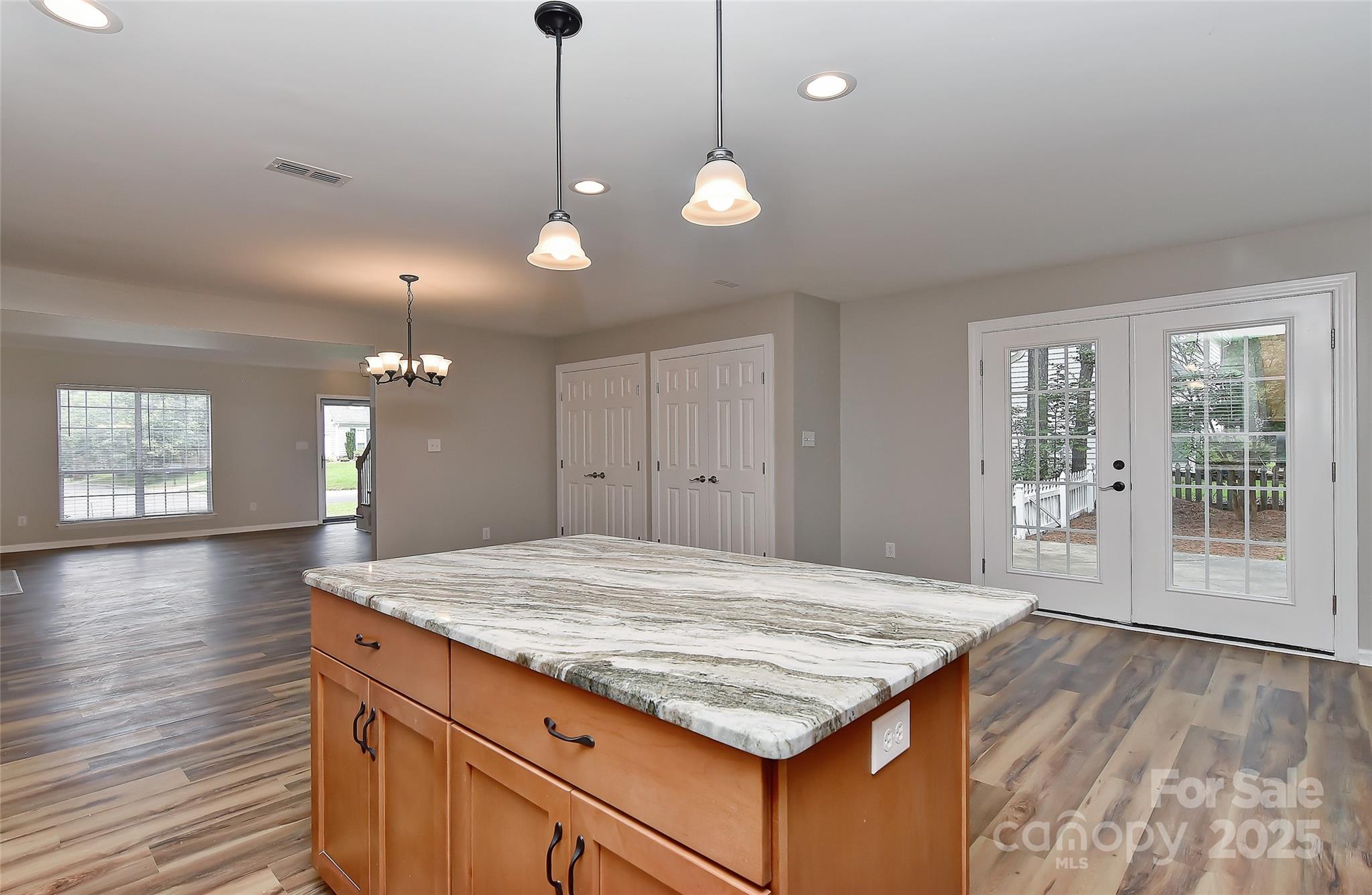 8056 Hunley Ridge Road Matthews, NC 28104 - Photo 8 of 37 a kitchen with kitchen island a stove and a wooden floor