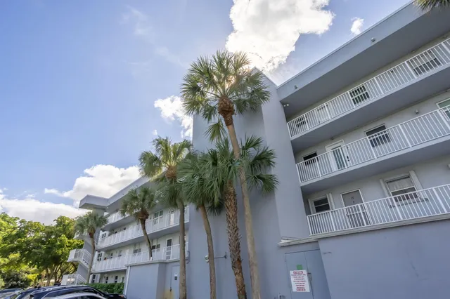 a view of a house with a palm tree