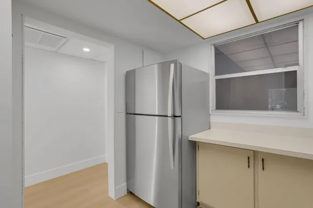 a kitchen with a refrigerator and microwave