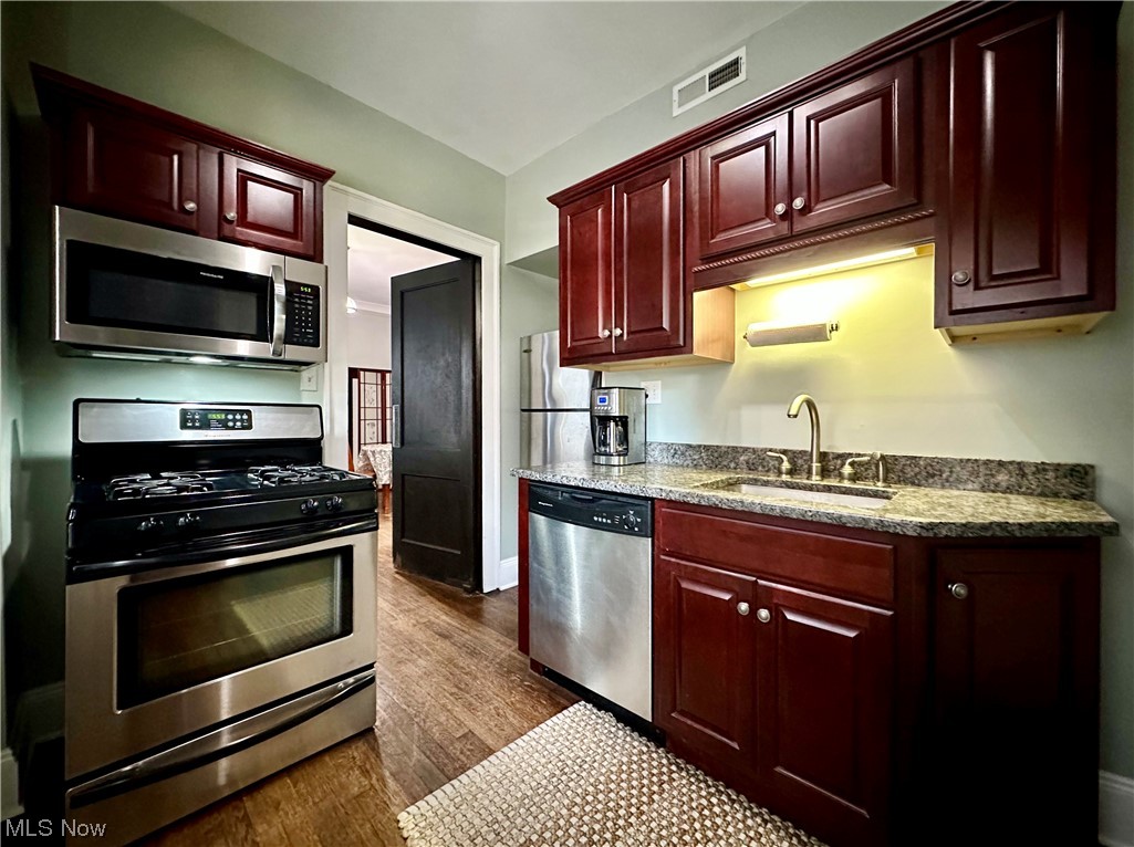 2469 Overlook Road, Unit 3 Cleveland, OH 44106 - Photo 30 of 35 Contemporary Kitchen with striking dark cabinets, granite countertops and stainless steel appliances including the refrigerator, dishwasher, range, and microwave.