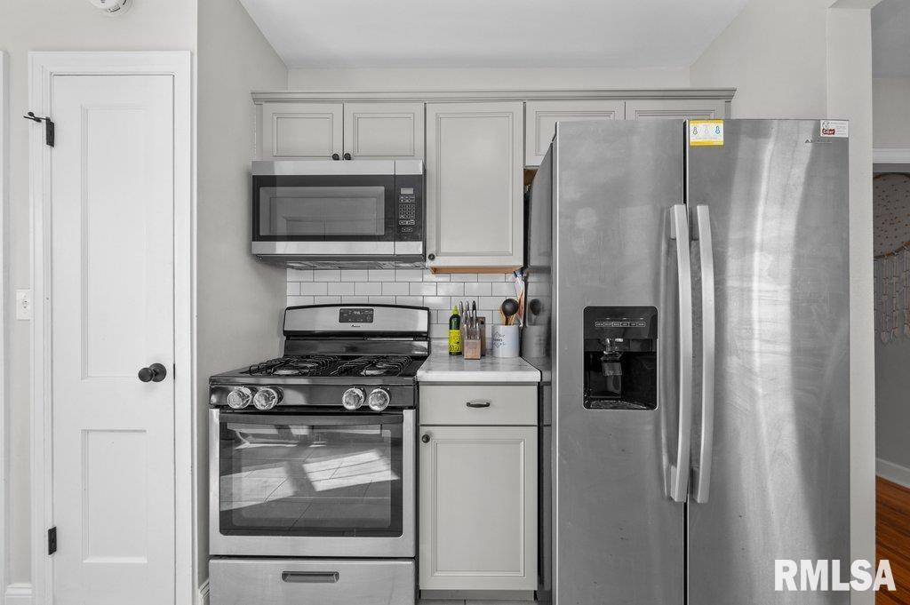 2133 Warren Street Davenport, IA 52804 - Photo 11 of 26 a kitchen with stainless steel appliances a refrigerator stove and microwave