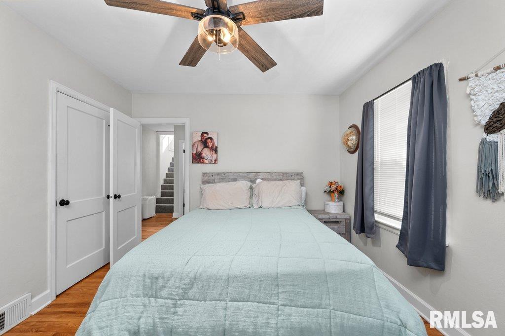 2133 Warren Street Davenport, IA 52804 - Photo 13 of 26 a bedroom with a large bed and a chandelier