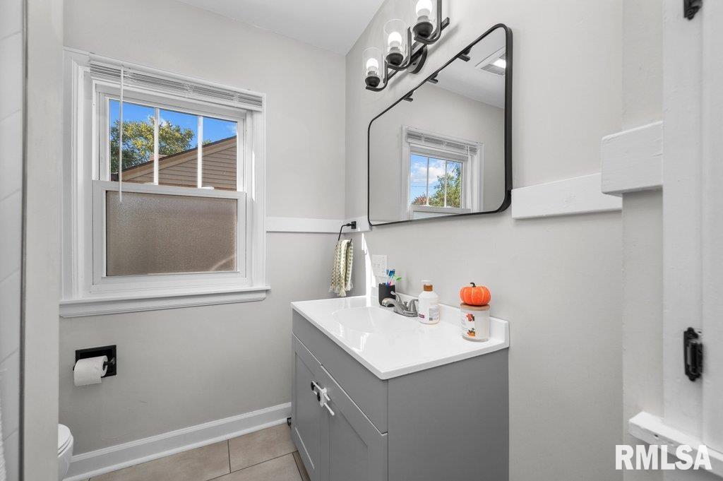 2133 Warren Street Davenport, IA 52804 - Photo 14 of 26 a bathroom with a sink and a mirror