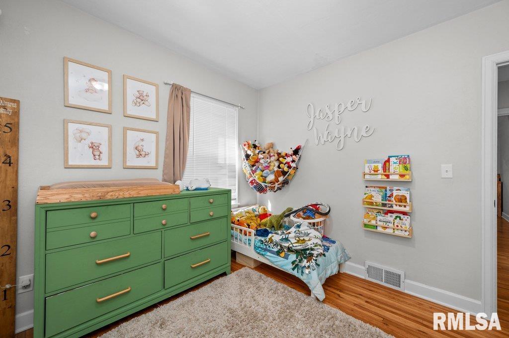 2133 Warren Street Davenport, IA 52804 - Photo 15 of 26 a room with toys and dresser with wooden floor