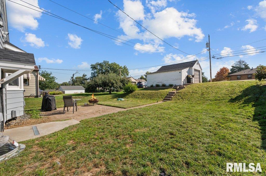 2133 Warren Street Davenport, IA 52804 - Photo 24 of 26 a swimming pool with outdoor seating and yard