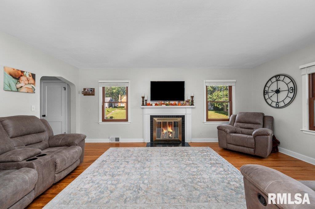 2133 Warren Street Davenport, IA 52804 - Photo 6 of 26 a living room with furniture a clock and a flat screen tv