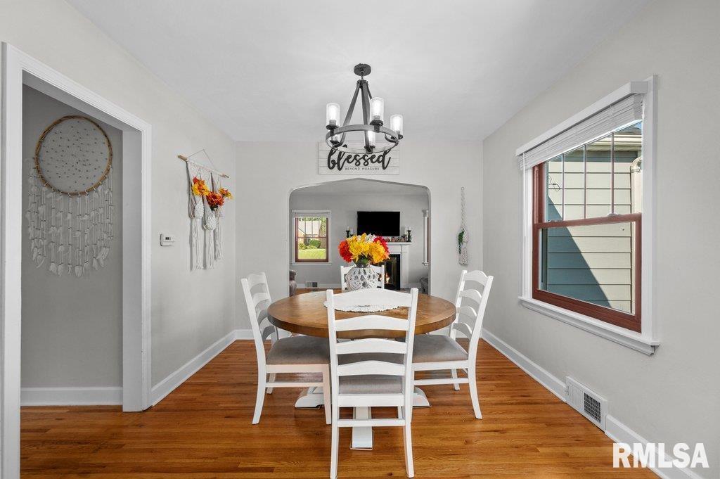 2133 Warren Street Davenport, IA 52804 - Photo 7 of 26 a dining room with furniture a chandelier and wooden floor