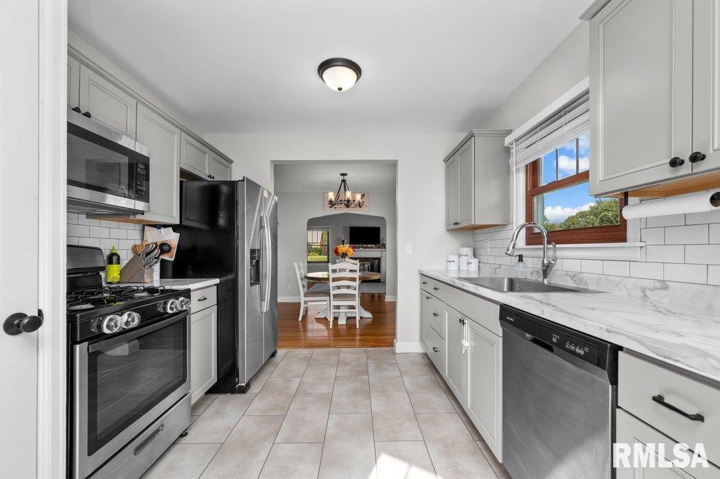 2133 Warren Street Davenport, IA 52804 - Photo 10 of 26 a kitchen with stainless steel appliances a stove sink and refrigerator